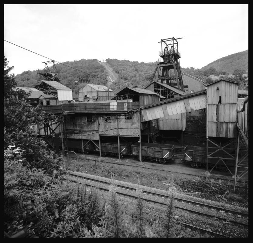 Black and white film negative showing a surface view of Celynen South Colliery, 1978. The headframe was built by E.Finch &amp; Co of Chepstow.