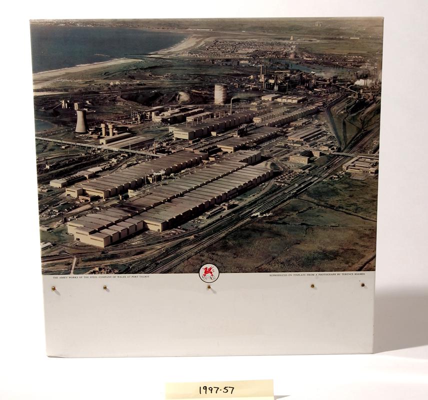 Colour photograph on tinplate showing aerial view of &quot;The Abbey Works of the Steel Company of Wales at Port Talbot&quot;.