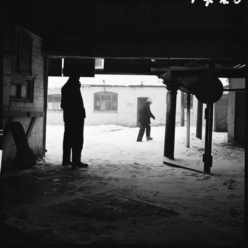 Black and white film negative showing two men in the yard, Big Pit.
