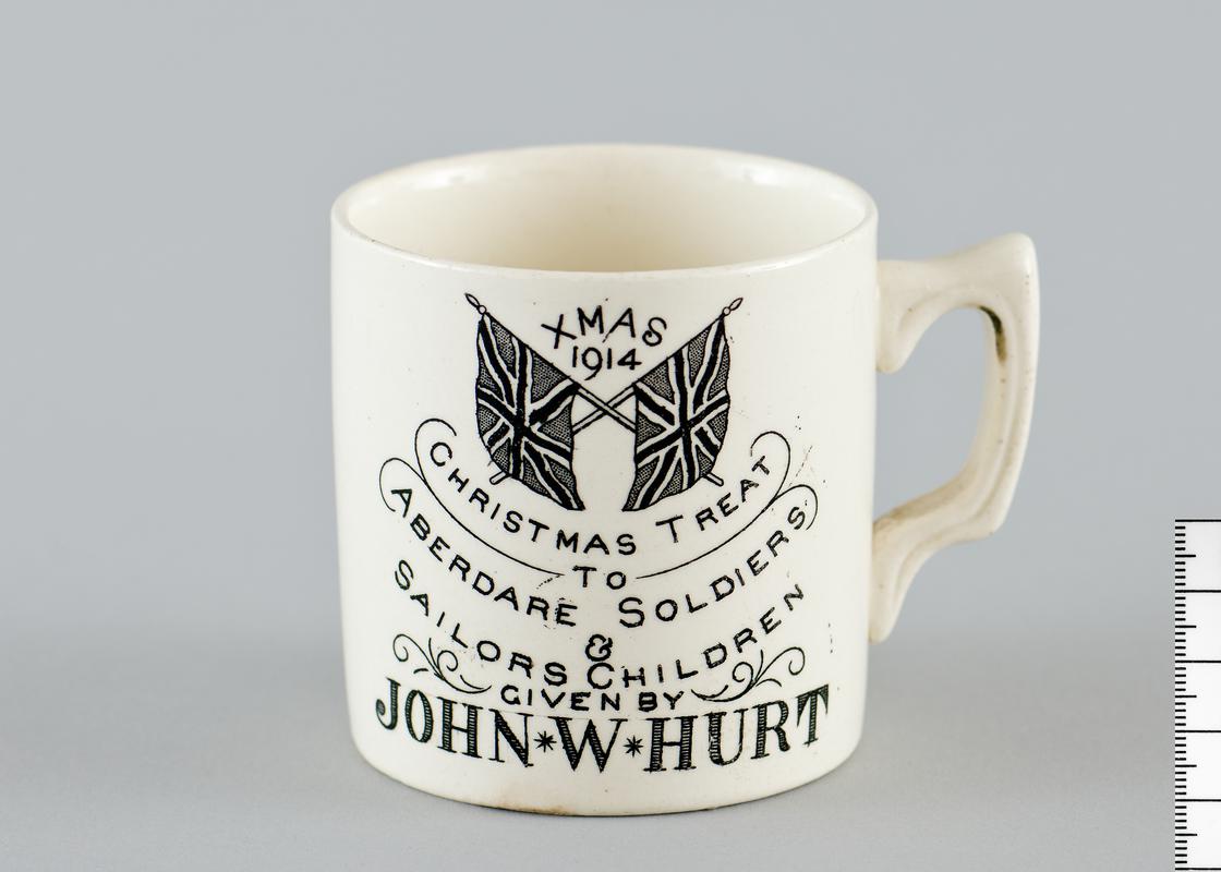 Ceramic commemorative tankard, World War I, Christmas 1914. White with inscription and 2 Union Jack flags in black and white.