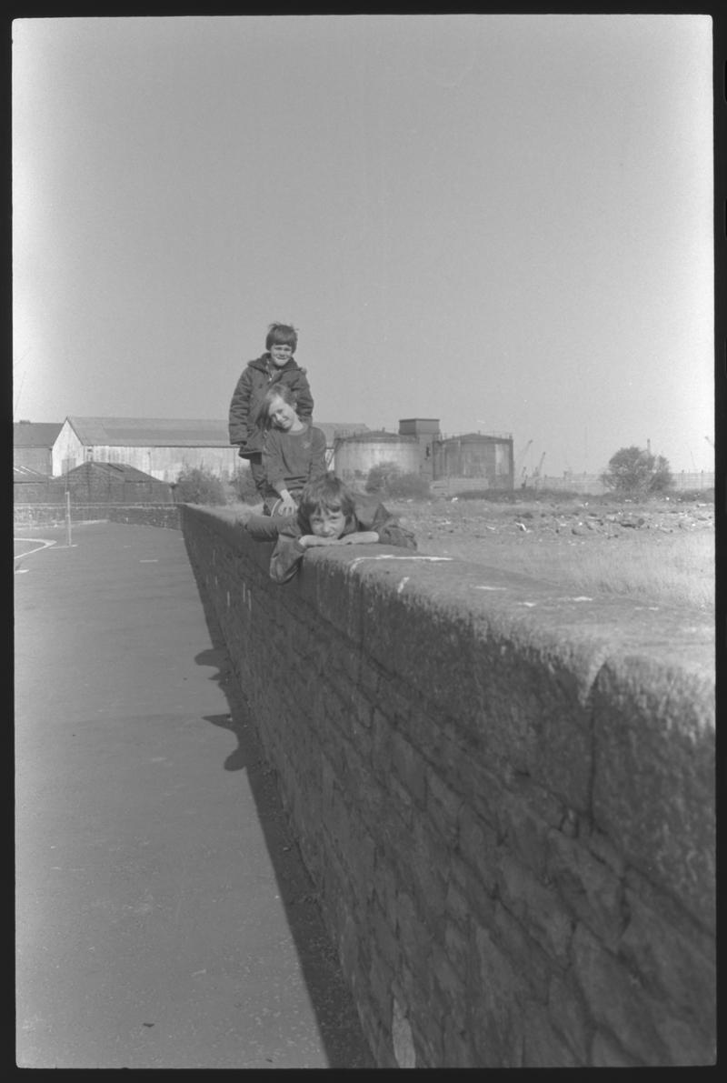 Children sitting on wall (foreshore) bordering Windsor Esplanade.