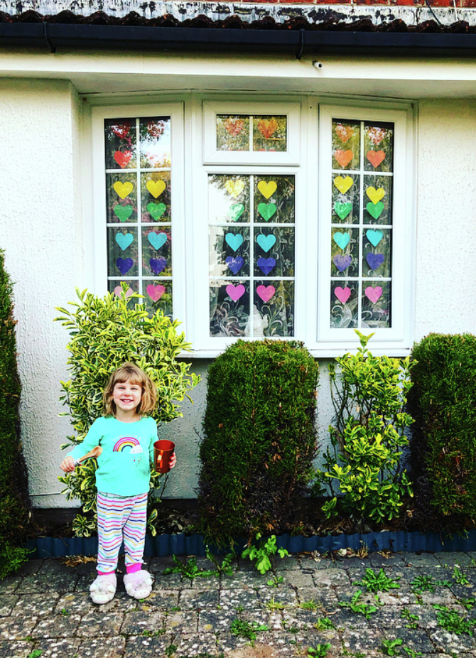 Thursday evening Clap for Carers my daughter Ella standing in front of our Thank you NHS window.