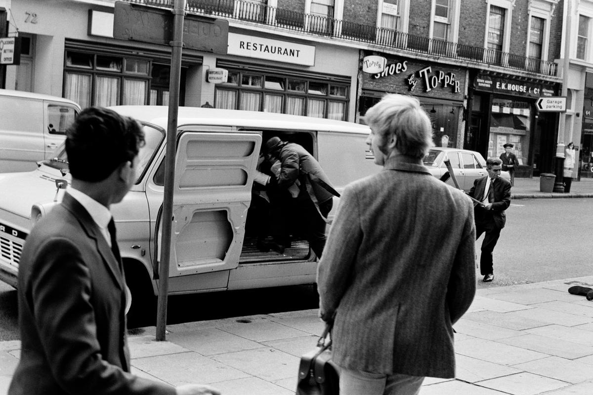 GB. ENGLAND. London. Queensway. Smash and grab raid on A B David jewellers and Silversmiths. Photographed when I was on my way to my ritual morning coffee. Published as a wrap around cover of the Sunday Mirror. 1969. (Image 1/8)