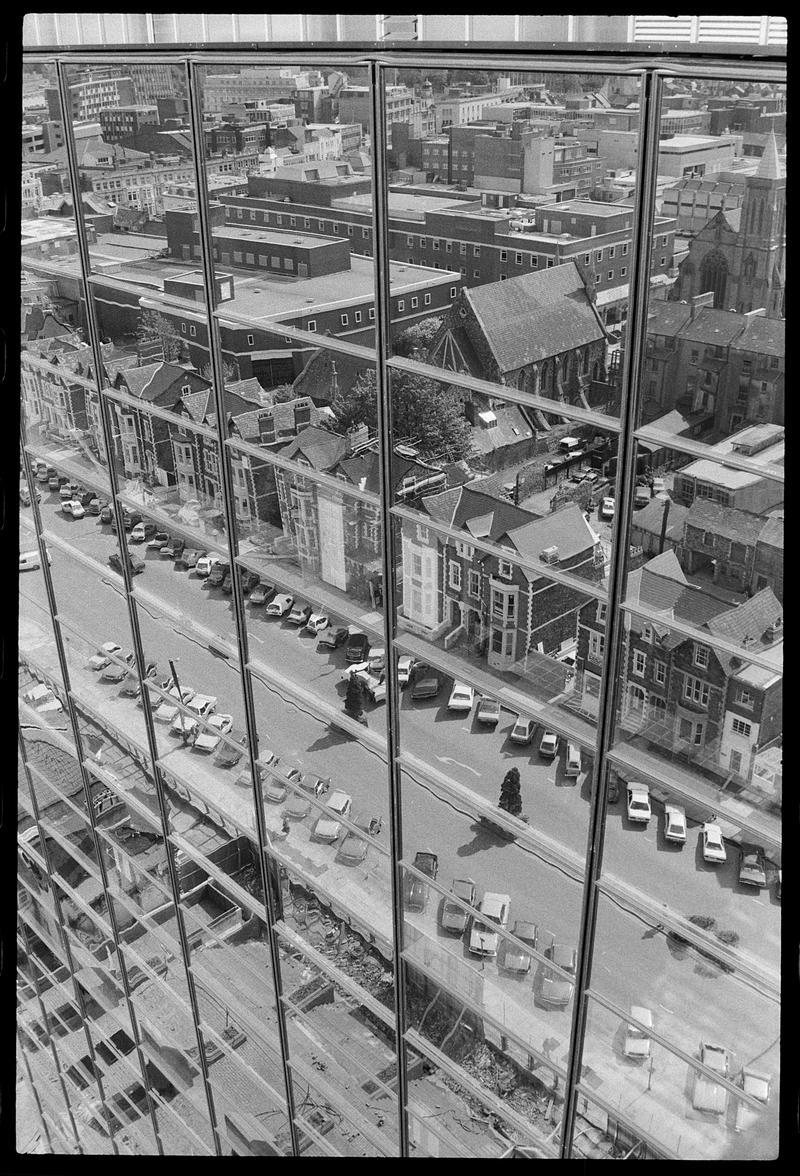 Churchill Way reflected in windows of building.