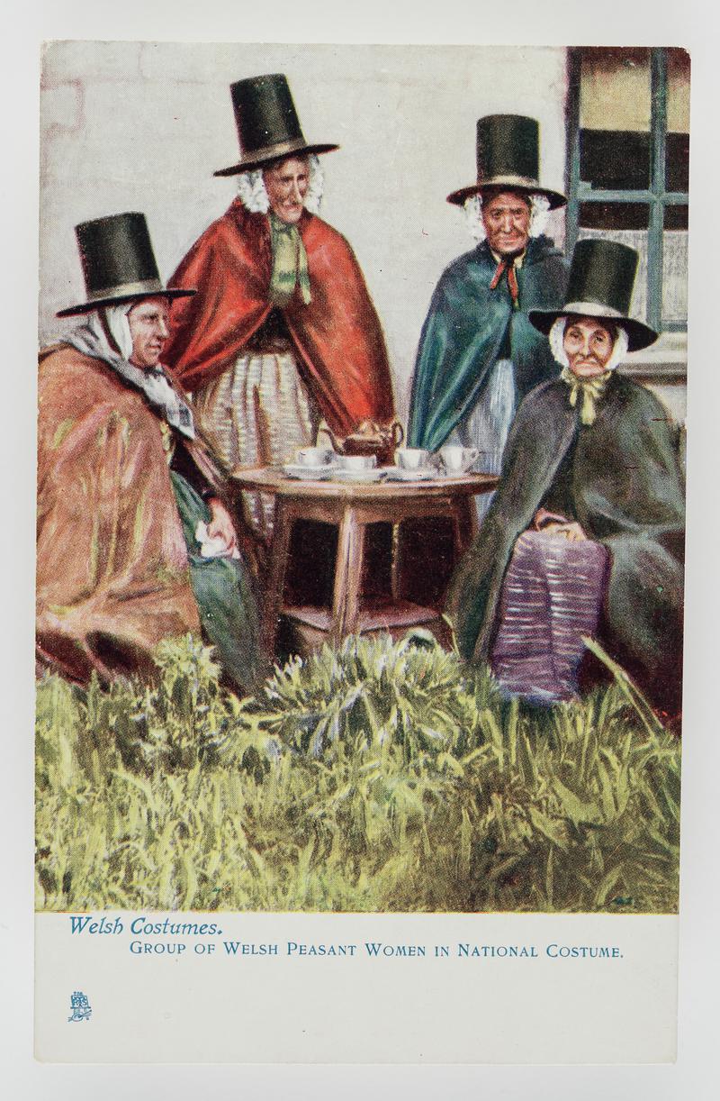 Group of 4 Welsh peasant women in National costume - by a small table in garden.