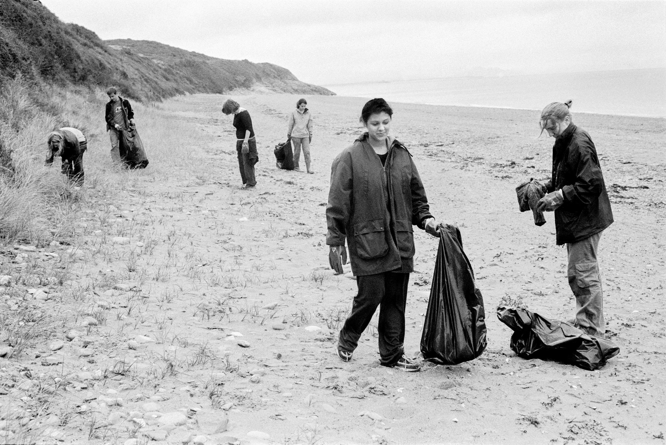 National Trust volunteers litter sweep on the beach. Llanbedrog, Wales