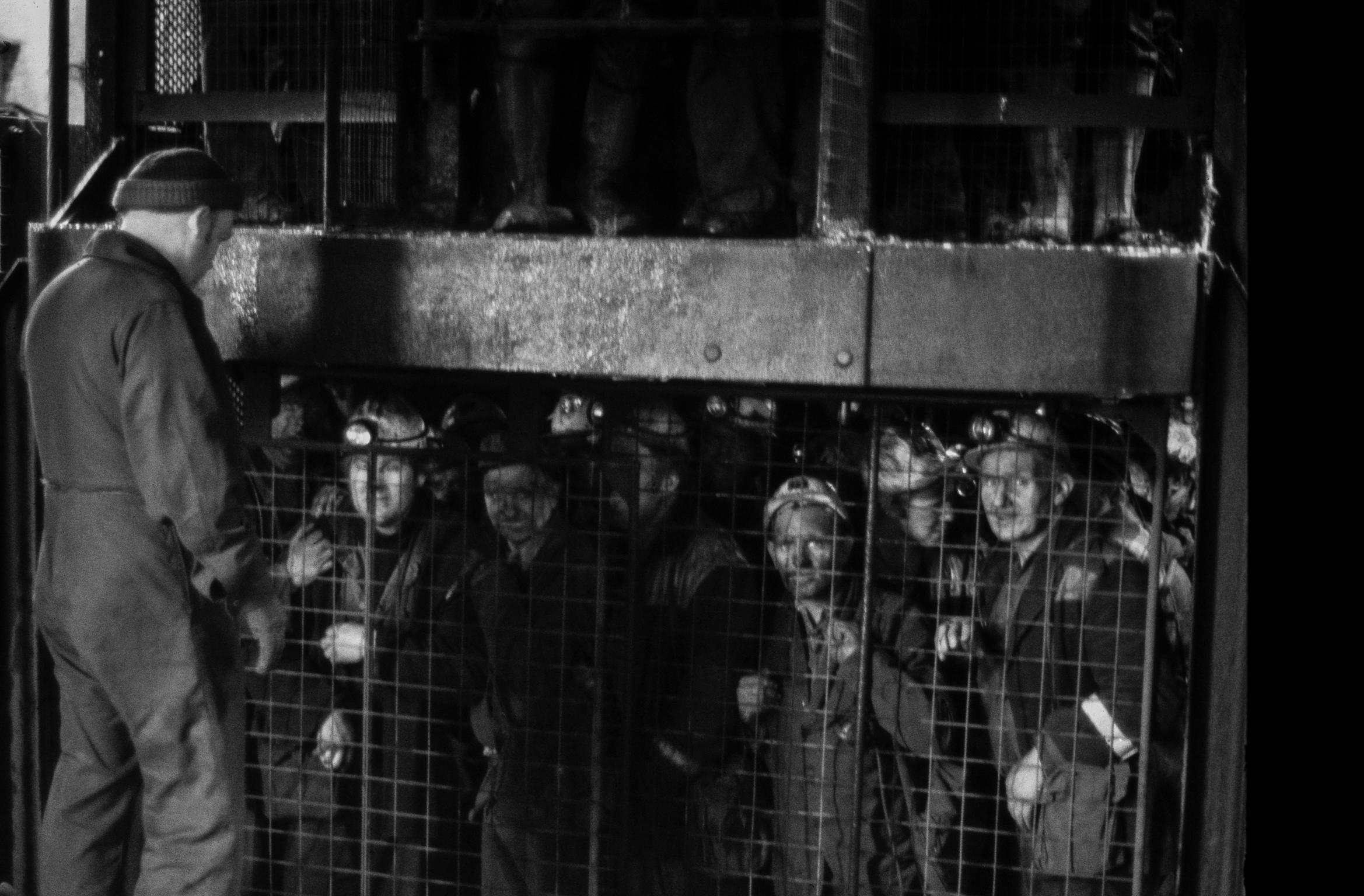 Miners coming up in the cage at the end of a shift. Rhondda Valley, Wales