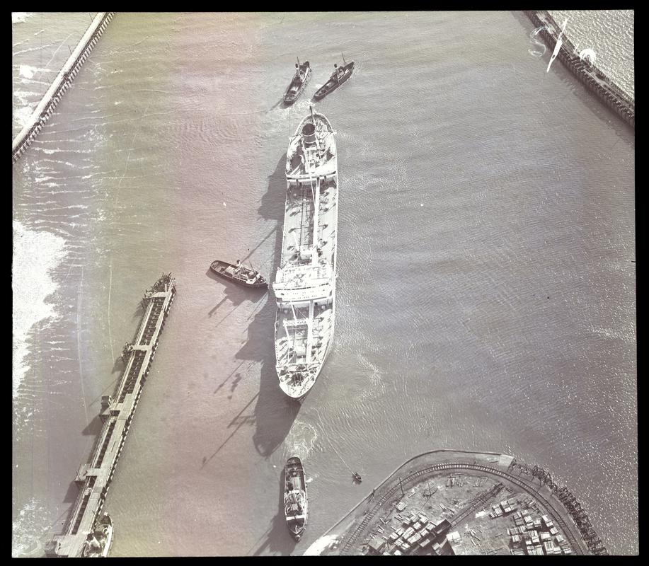 Aerial view showing the mv EIKO MARU (894 GT) built 1948 at Kogyo and owned by Sanko Kissen KK, being towed into Swansea Dock, 22 March 1952. This was the first Japanese vessel to enter Swansea for twelve years.