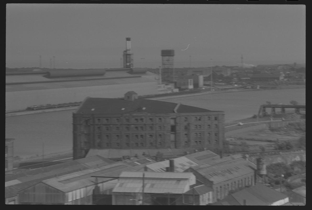 View of Butetown, with East Dock and Castle Works on the left, warehouses on Collingdon Road in foreground and dockside cranes in background.