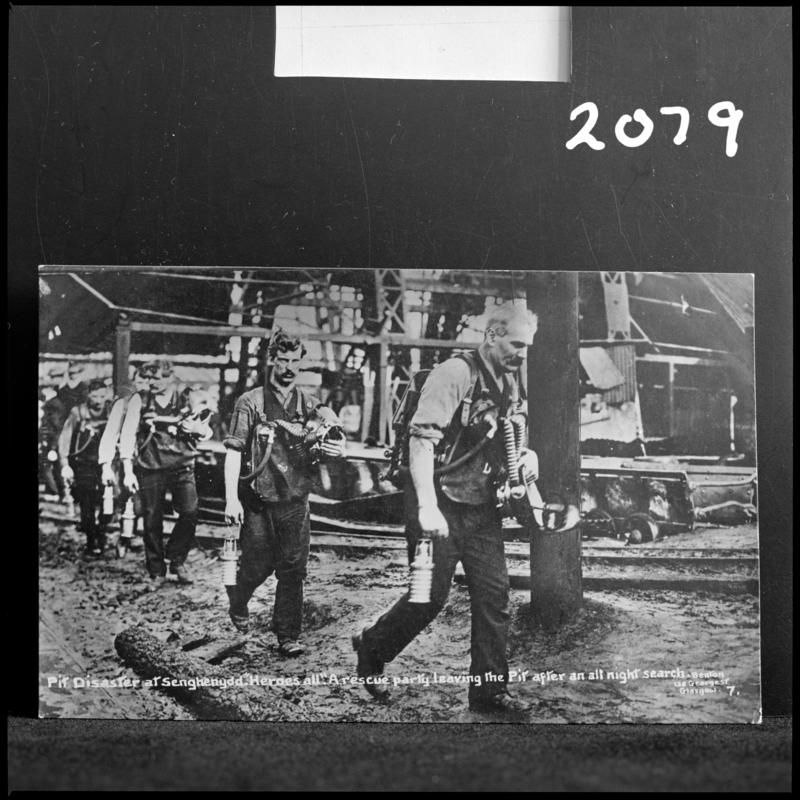 Black and white film negative of a photograph showing the scene at Universal Colliery, Senghenydd after the explosion of 14 October 1913.  Caption on photograph reads &#039;Pit Disaster at Senghenydd.  A rescue party leaving the Pit after an all night search&#039;.