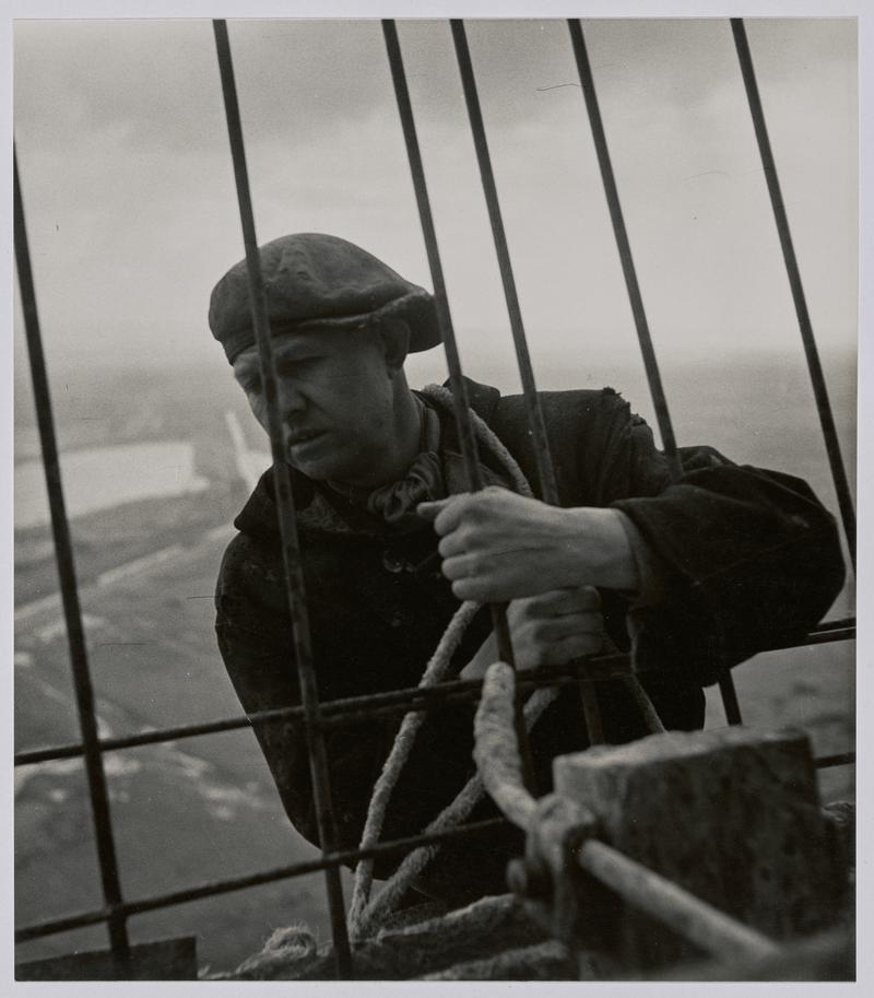 &quot;Building the cooling tower&quot; - Portrait of construction worker at the top of concrete cooling tower, Port Talbot. - Photographs of steelworks and South Wales [See also - NMW A 57568 ]