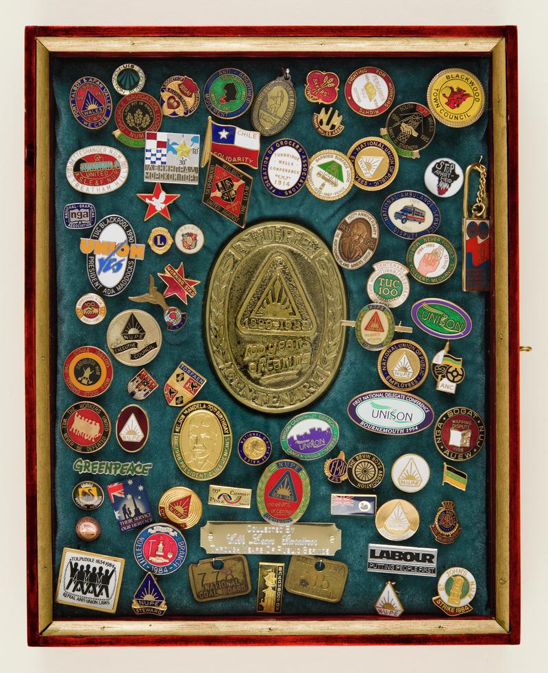Boxed collection of trade union and political badges collected by donor during his years as a trade union member with NUM and late NUPE (Unison).