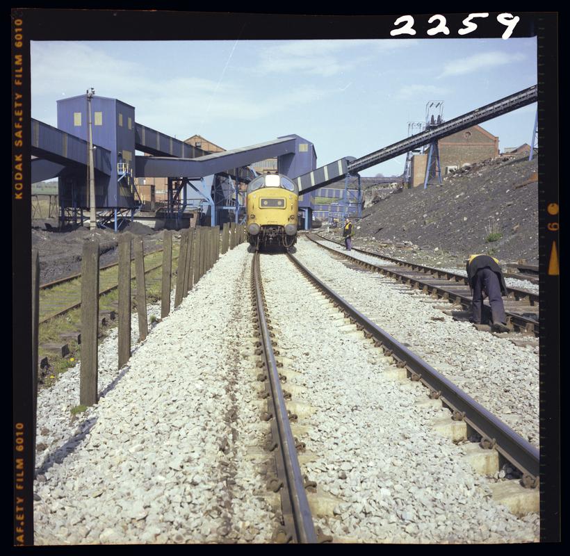 Colour film negative showing a locomotive passing through Oakdale Colliery, 16 April 1981.  &#039;Oakdale 16/4/81&#039; is transcribed from original negative bag.