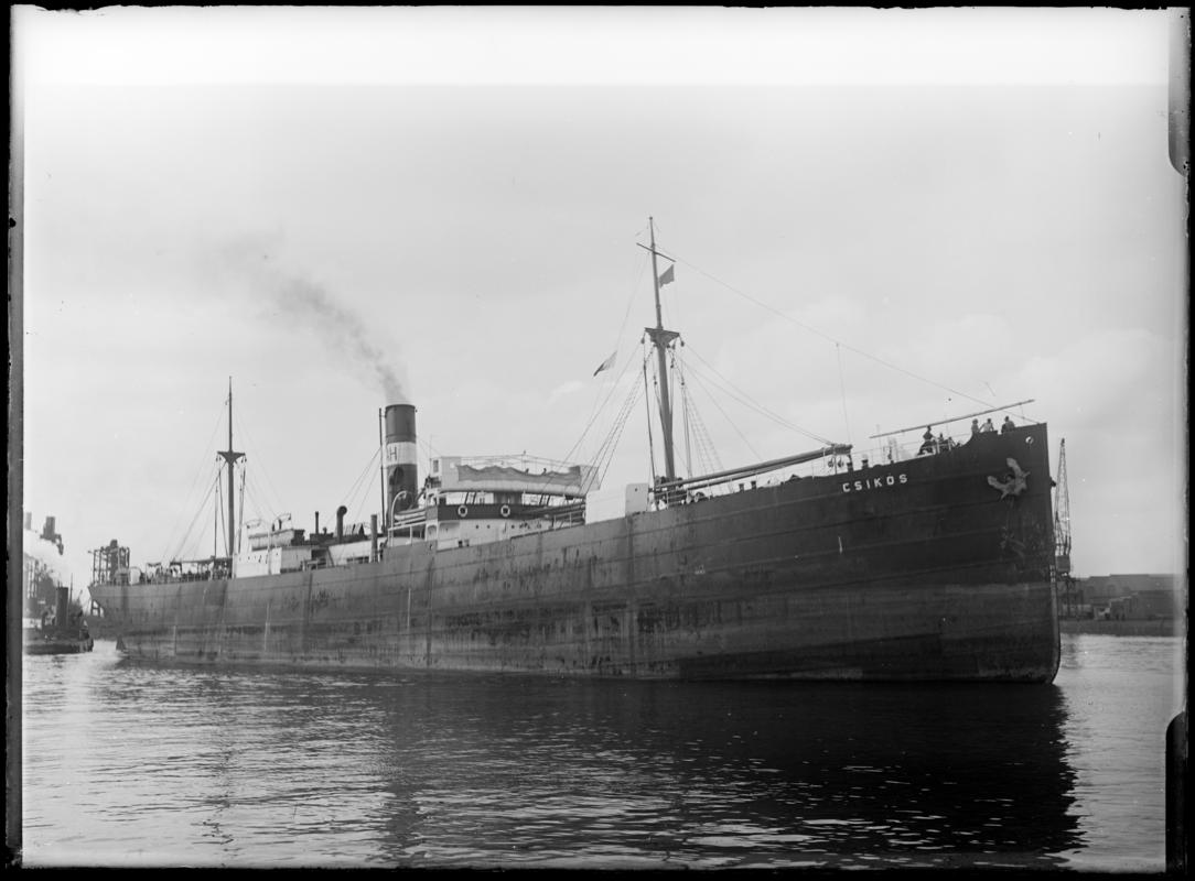 Three quarter Starboard bow view of S.S. CSIKOS and tug, c.1936.