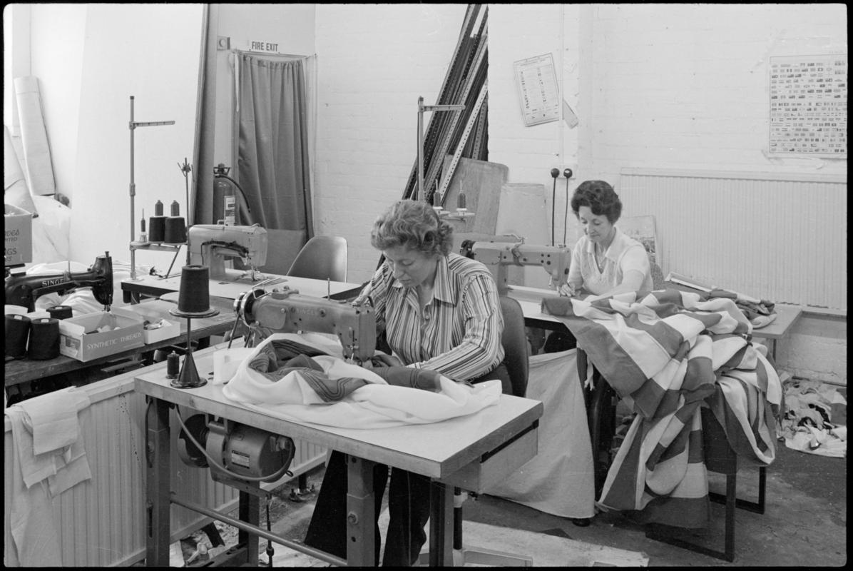 Interior view of J.G Eveleigh and Company flagmakers workshop at Hunter Street, Cardiff Docks showing Mrs Jean Eveleigh and assistant using sewing machines.