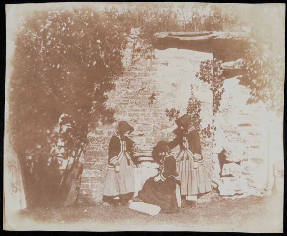 Three girls in garden, photograph