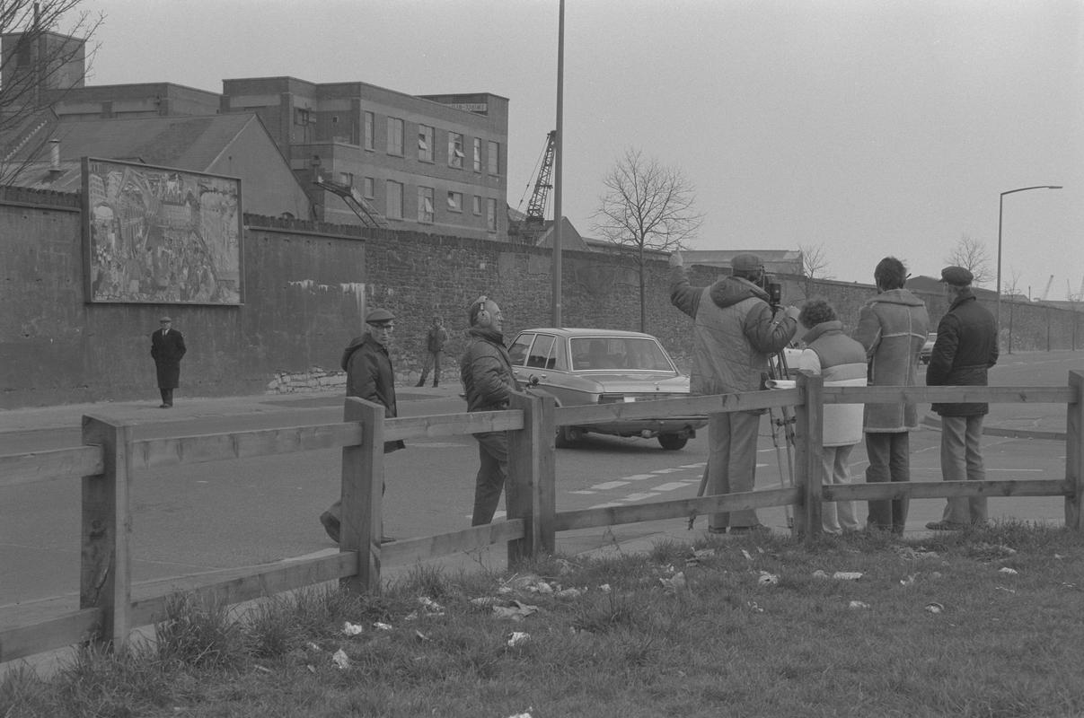 Film crew on Bute Street opposite mural on wall of railway embankment.