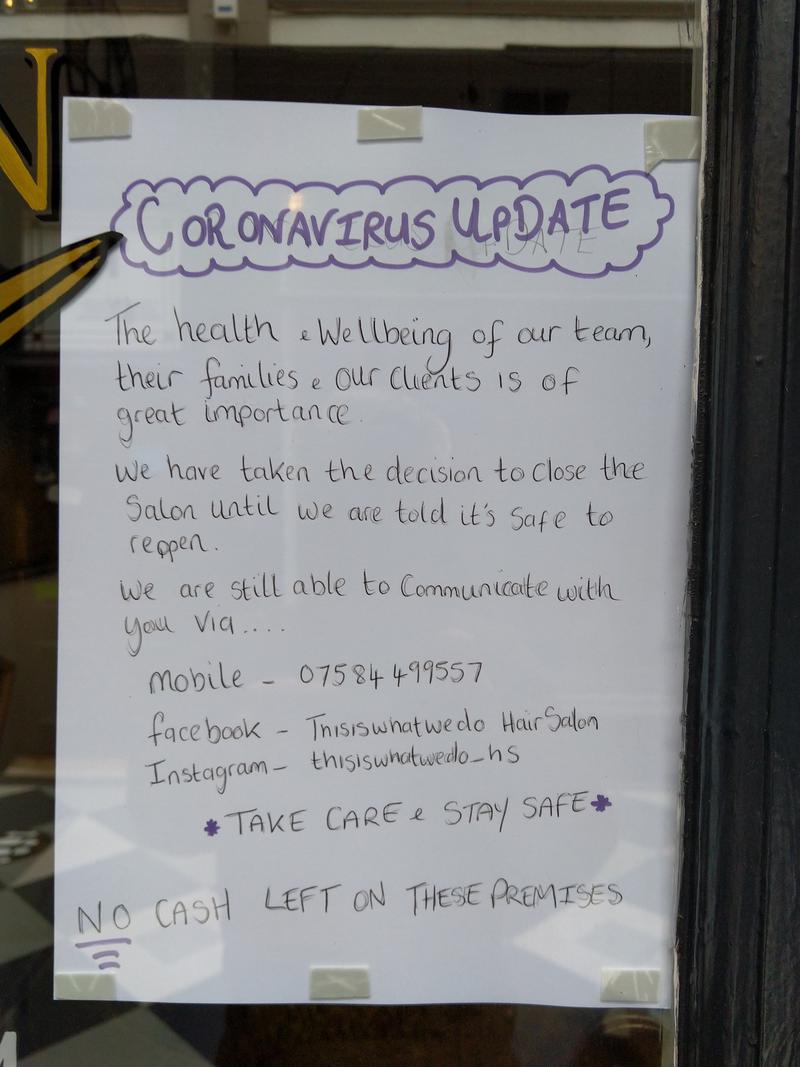 &#039;Coronavirus Update&#039; notice on the door of a hairdressers in High Street Arcade, Cardiff.