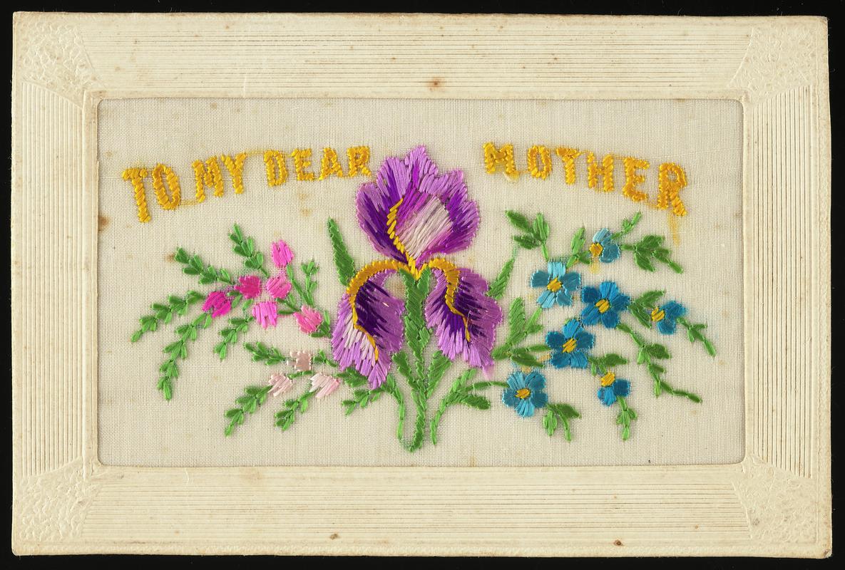 Embroidered silk postcard inscribed To My Dear Mother. Sent by Gordon Hobbs to his mother during First World War. Dated Aug 22nd 1917. Embroidered with floral motif of purple iris and sprays of pink and blue flowers either side. Message on back.