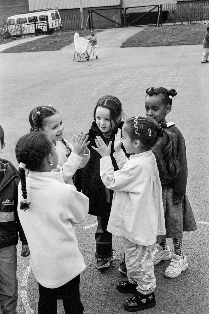 GB. WALES. Cardiff. Bute Town. St Marys school in the playground. Ethnic diversity. 2000.