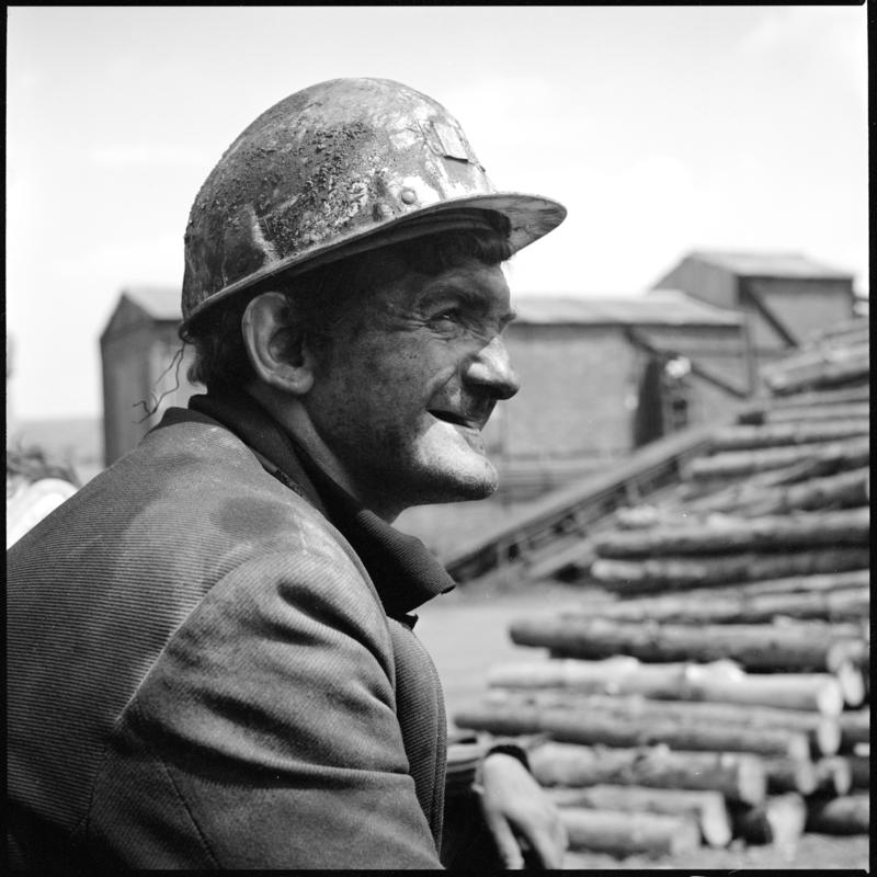 Black and white film negative showing a miner in the timber yard at the end of the morning shift, Big Pit 1978.