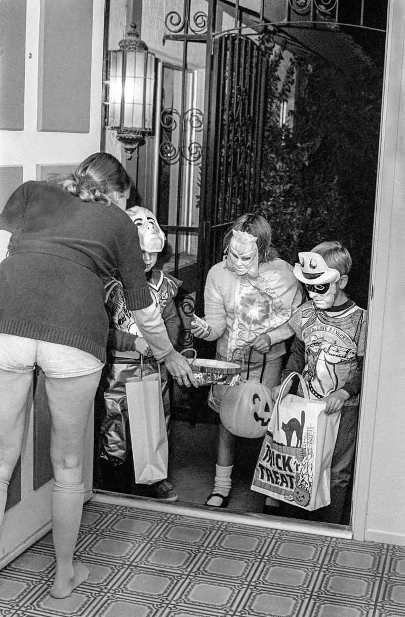 USA. ARIZONA. Tempe. Three youths dressed in typical fancy dress go round the local houses for the traditional Trick or Treat. 1979.