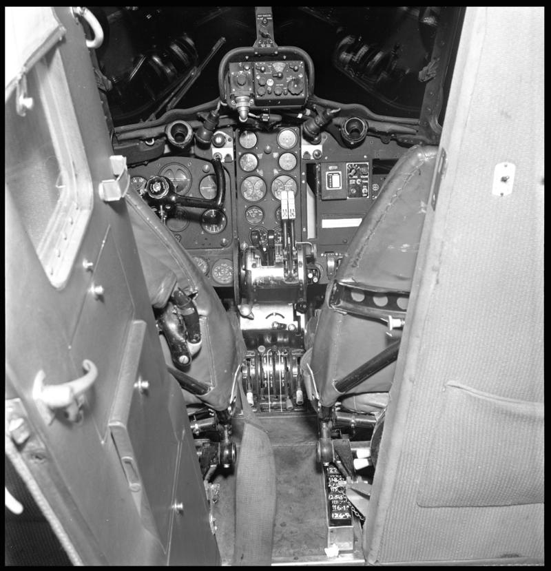 View into the cockpit from the passenger cabin of a Cambrian Air Services&#039; De Havilland Dove aircraft.