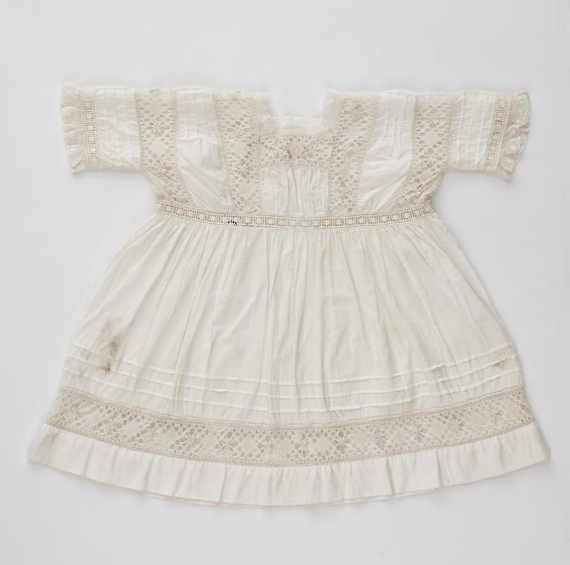 Baby&#039;s white cotton lawn frock with high waistline