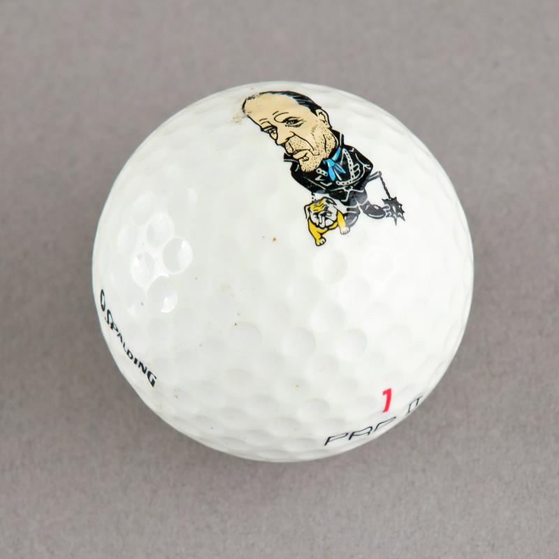 Golf ball with caricature of Norman Tebbit. Sold during 1984-85 Miners&#039; Strike.
