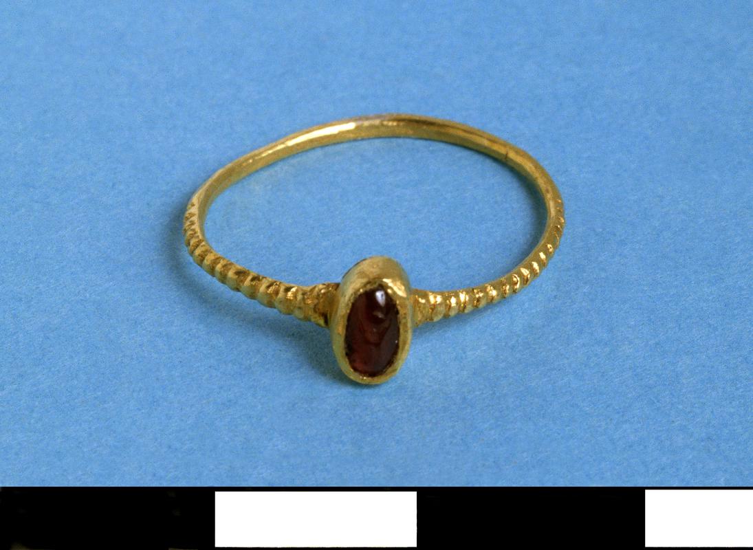 gold finger ring set with garnet.