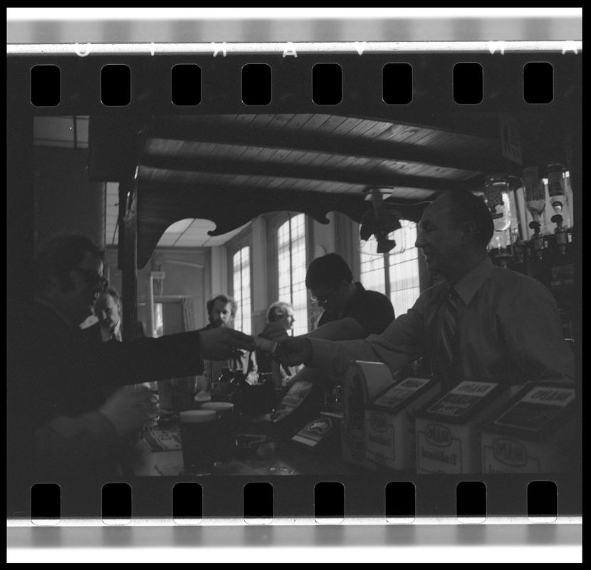 Barman serving drinks in the Dowlais Pub.