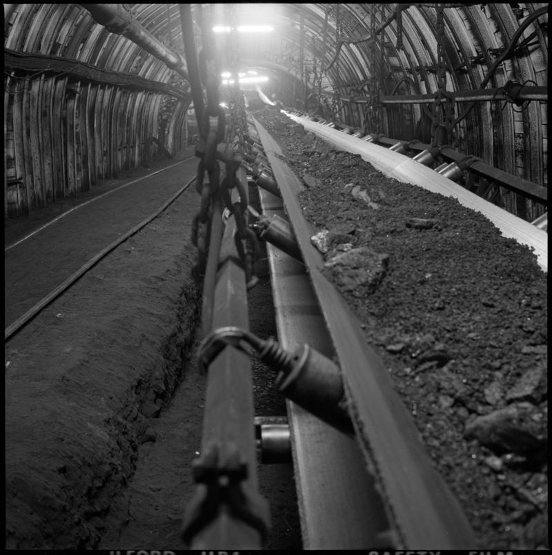 Black and white film negative showing a conveyor underground at Celynen North Colliery, 1978-9.  &#039;Celynen North 1978-9&#039; is transcribed from original negative bag.