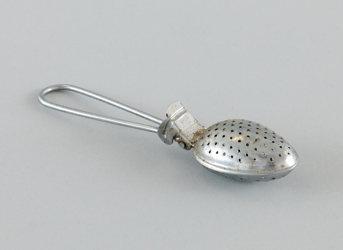 Wire handle tea brewer, teaspoon sized, used to brew loose tea.