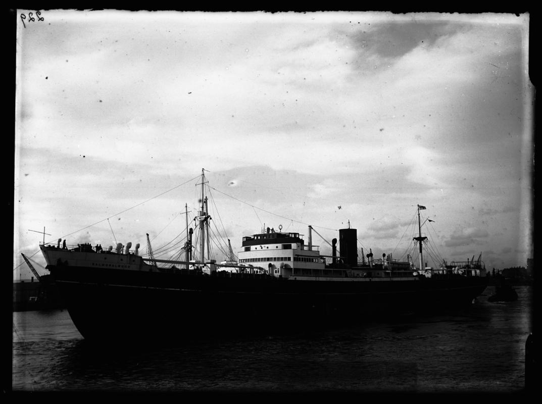 Port broadside view of S.S. BADJESTAN and tug at Cardiff docks, c.1936.