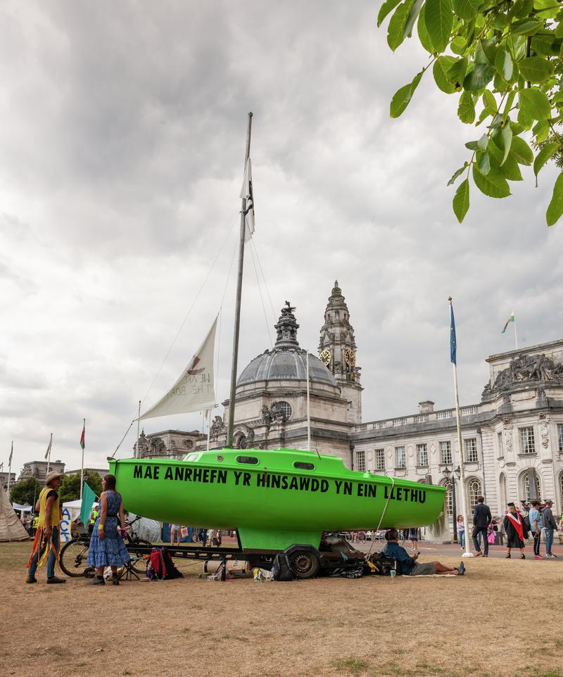 Extinction Rebellion Protest in Cardiff - Civic Centre, Museum and City Hall Lawn. Green Yachts with Protest Slogans painted on them.