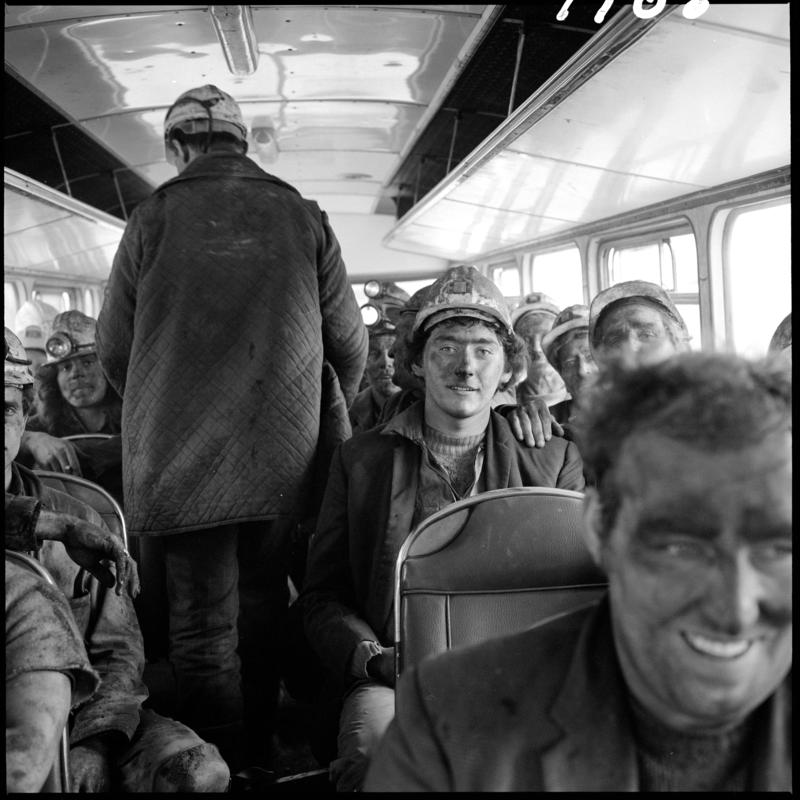 Black and white film negative showing miners sat on the National Coal Board bus in 1978.  It transported them from the Blaenavon Drift Mine to the pit head baths at Big Pit.