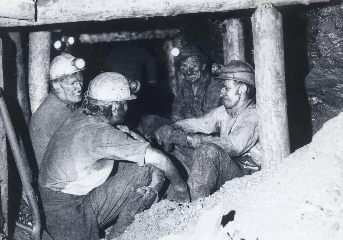 Group of four miners sitting at unknown coal face