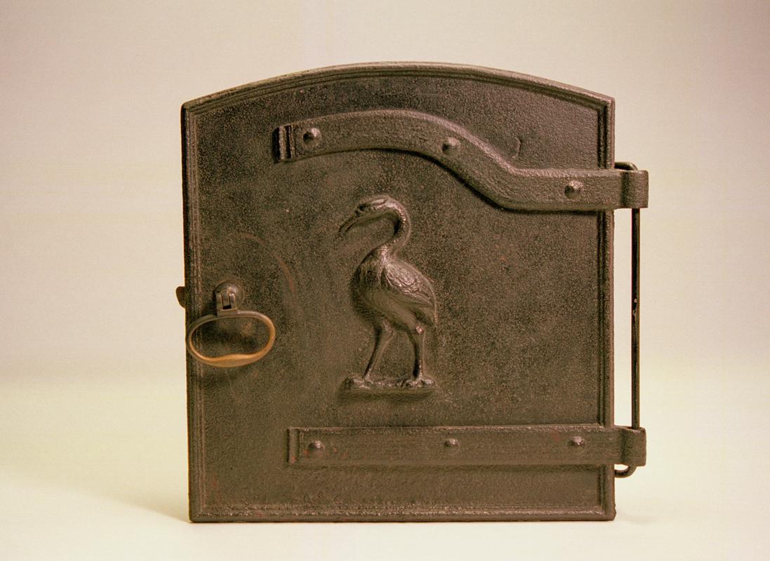 Cast iron oven door embossed with the image of a crane bird (George Crane of Ynyscedwyn Ironworks).