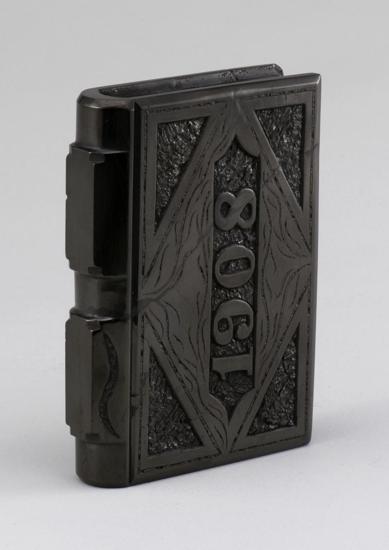 Coal carved in shape of a book