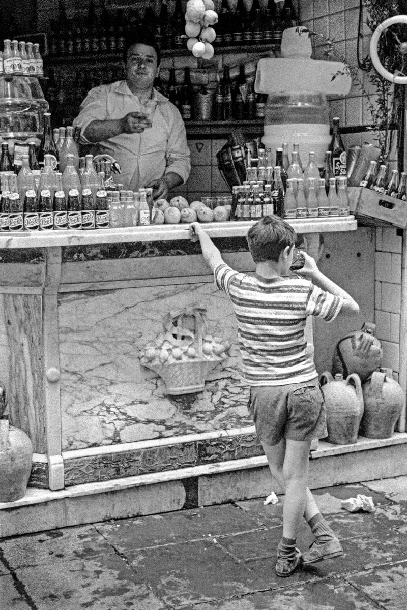 ITALY. Naples. A quick drink in a Naples side street. 1964.