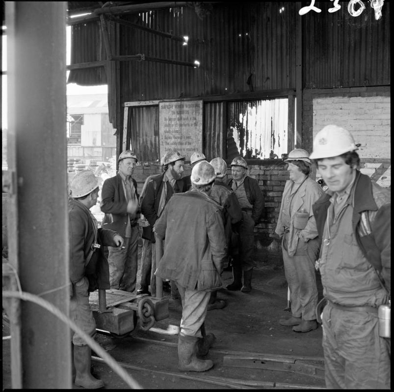 Black and white film negative showing a group of miners on the surface at Morlais Colliery, 13 May 1981.  &#039;Morlais 13/5/81&#039; is transcribed from original negative bag.