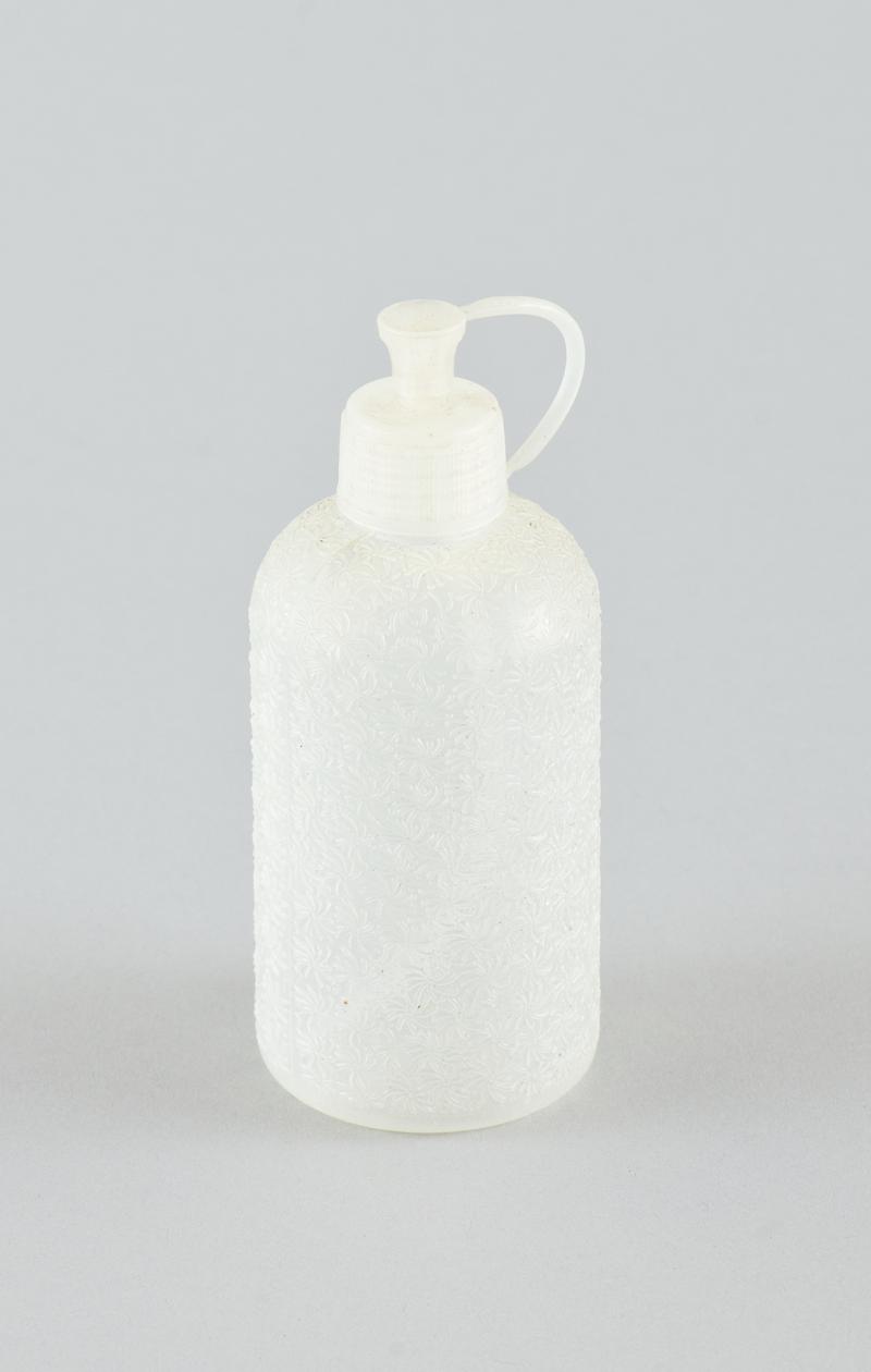 Clear plastic squeezy bottle with raised fern-like pattern over body [empty].