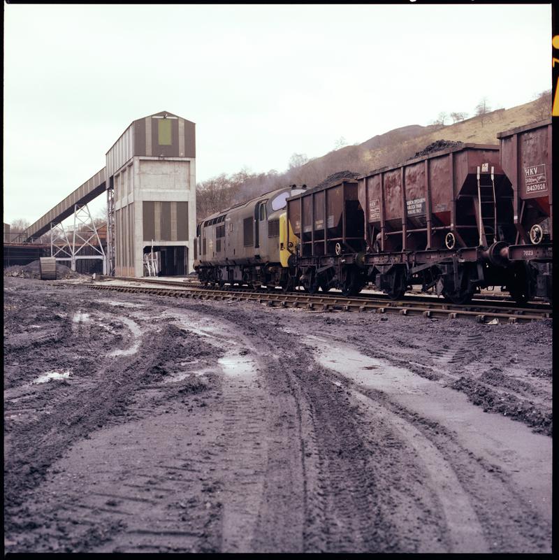 Colour film negative showing a locomotive passing through Taff Merthyr Colliery.