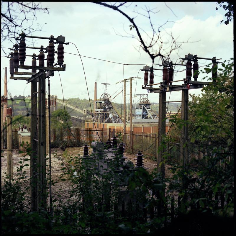Colour film negative showing a view towards the upcast and downcast shafts, Nantgarw Colliery with electricity pylons in the foreground.  &#039;Nantgarw&#039; is transcribed from original negative bag.