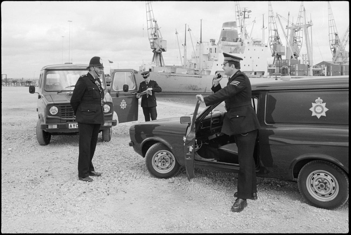 British Transport (Docks) Police at Queen Alexandra Docks, Cardiff. Large vessel in background. The policeman on the left wearing a helmet is PC William Power, the longest serving policeman (34 years) who started with the Great Western Railway