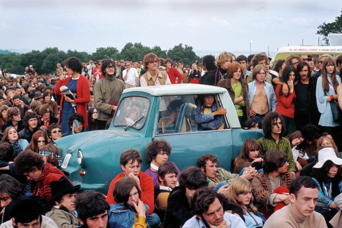 GB. ENGLAND. Isle of Wight Festival. It is nice to see that an invalids car is allowed to the front without any complaints from the crowd. 1969.