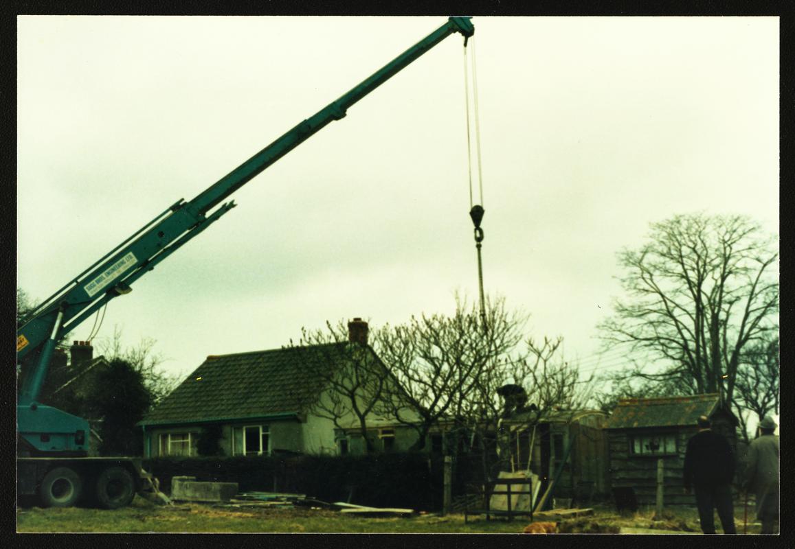 Colour photograph of large crane preparing to lift Cambrian Railways brake/3rd carriage body of c.1890 (acc.no. 87.116I) grounded at Ashcott, Somerset, for movement to Welsh Industrial &amp; Maritime Museum, 1988.