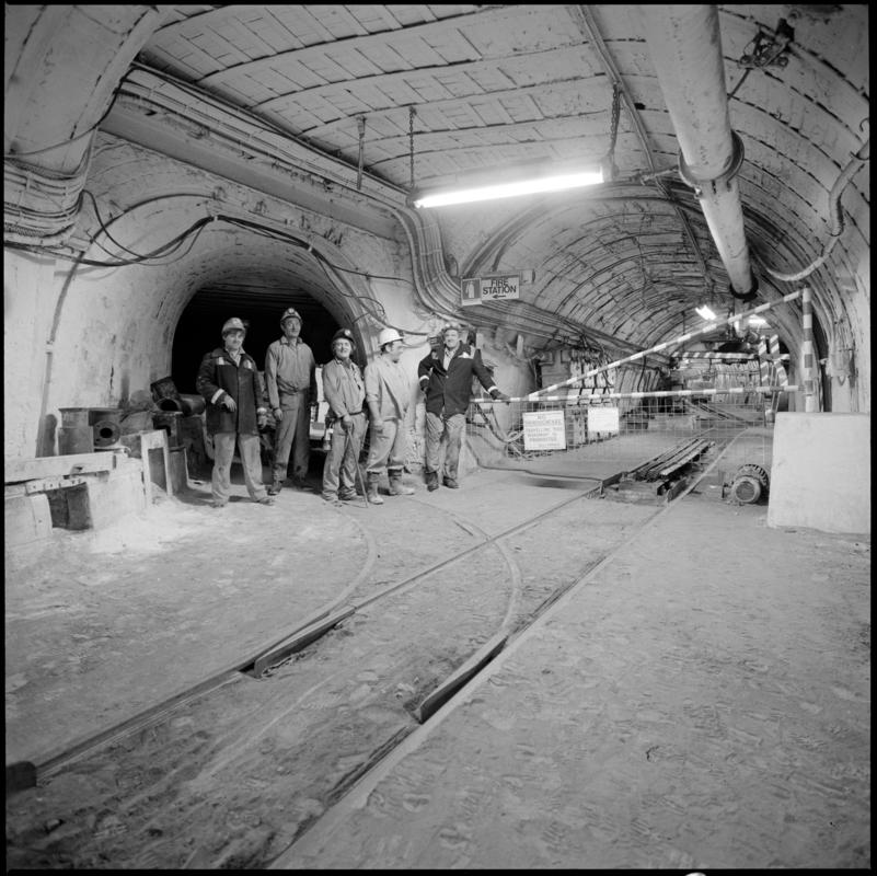 Black and white film negative showing a group of miners underground at Merthyr Vale Colliery, 2 July 1981.  &#039;Merthyr Vale 2 Jul 1981&#039; is transcribed from original negative bag.