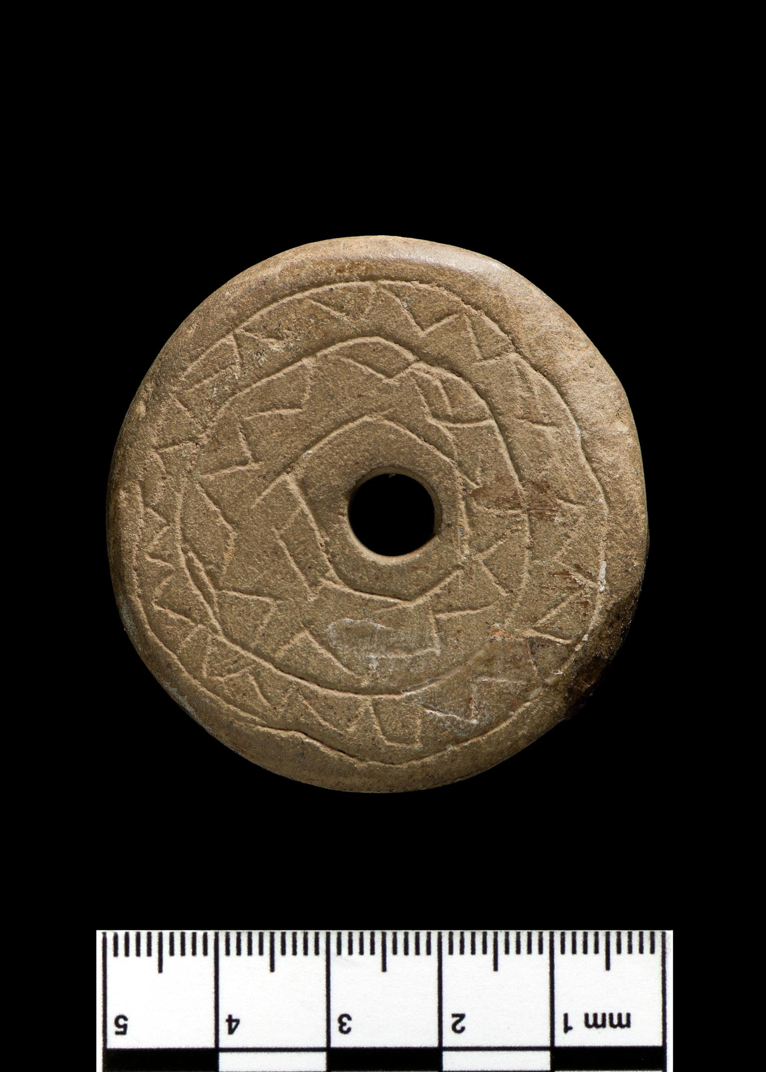 Medieval stone spindle whorl