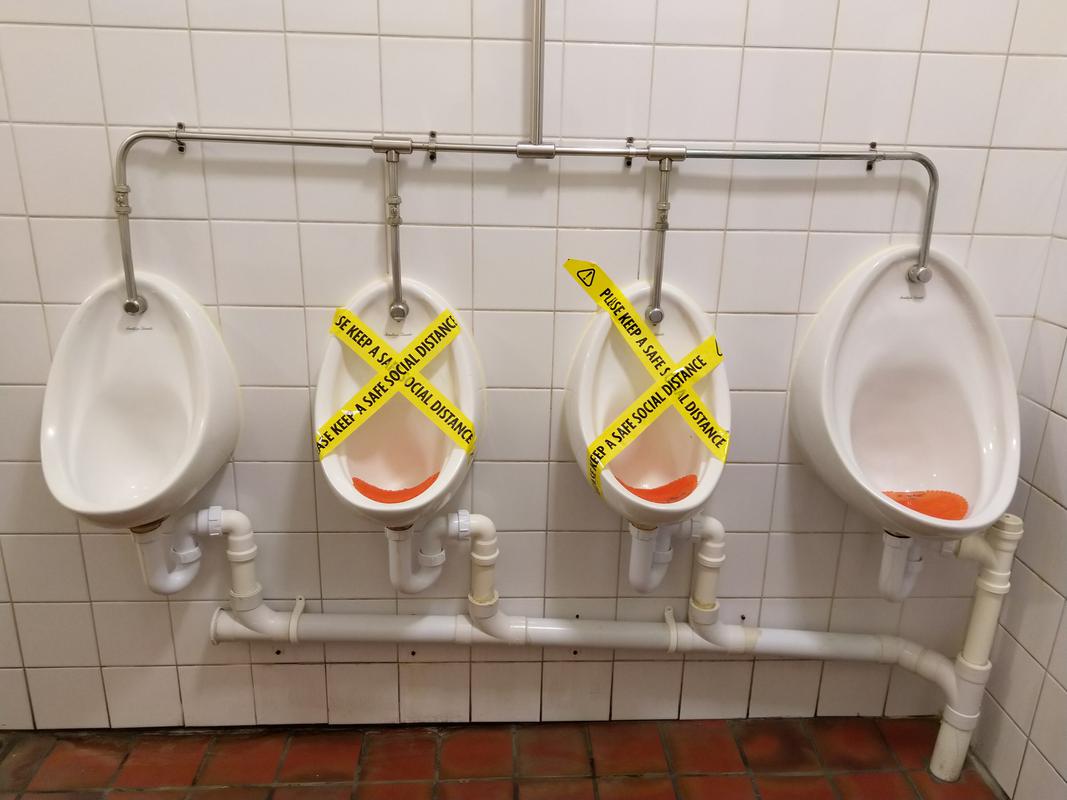 Urinals in The Golden Cross, Cardiff, closed off as part of social distancing.